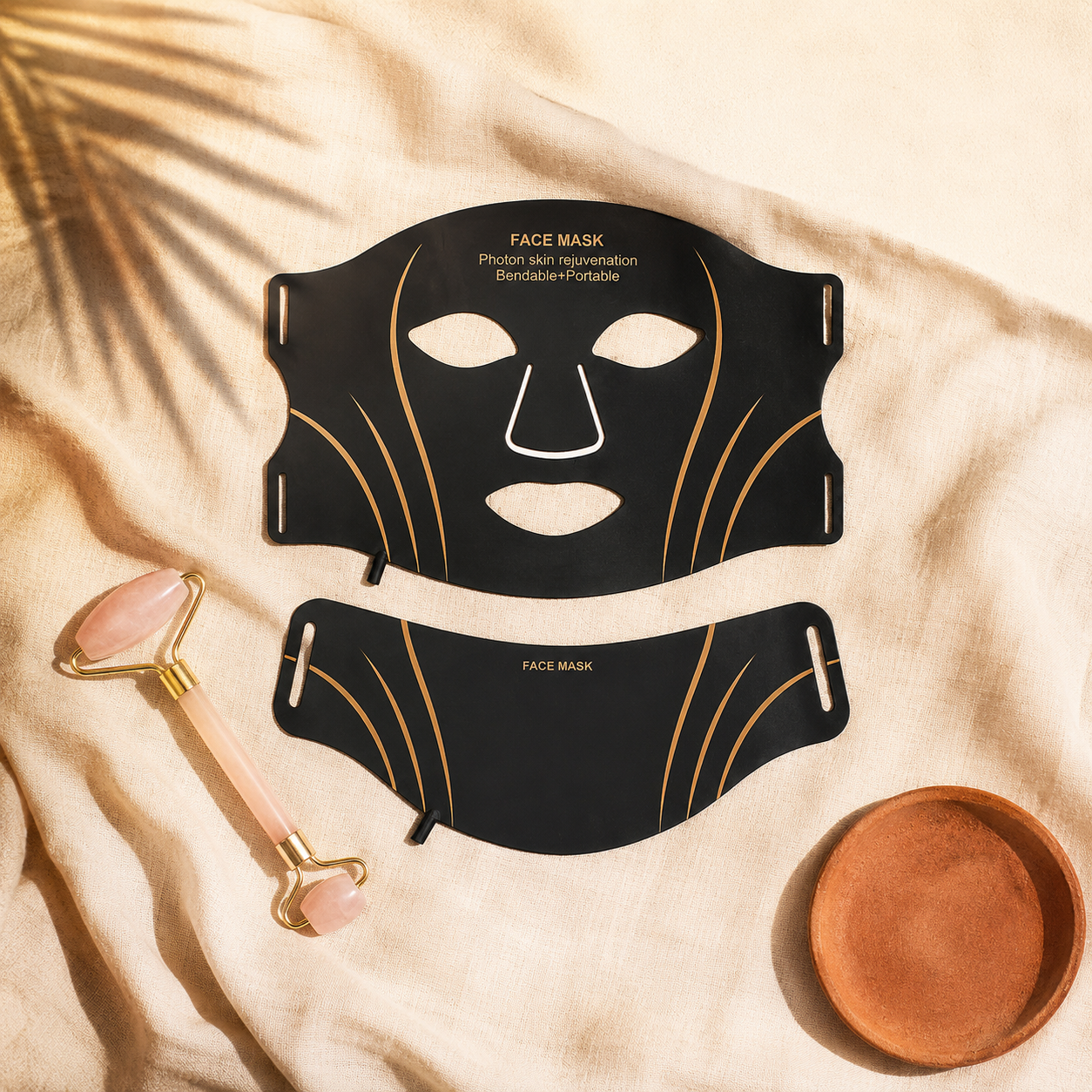 The Complete Set — LED face mask, neck piece and rose-quartz facial roller on warm cream linen